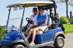 Two Golf Classic attendees in their golf cart