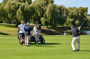 A Golf Classic attendees swings