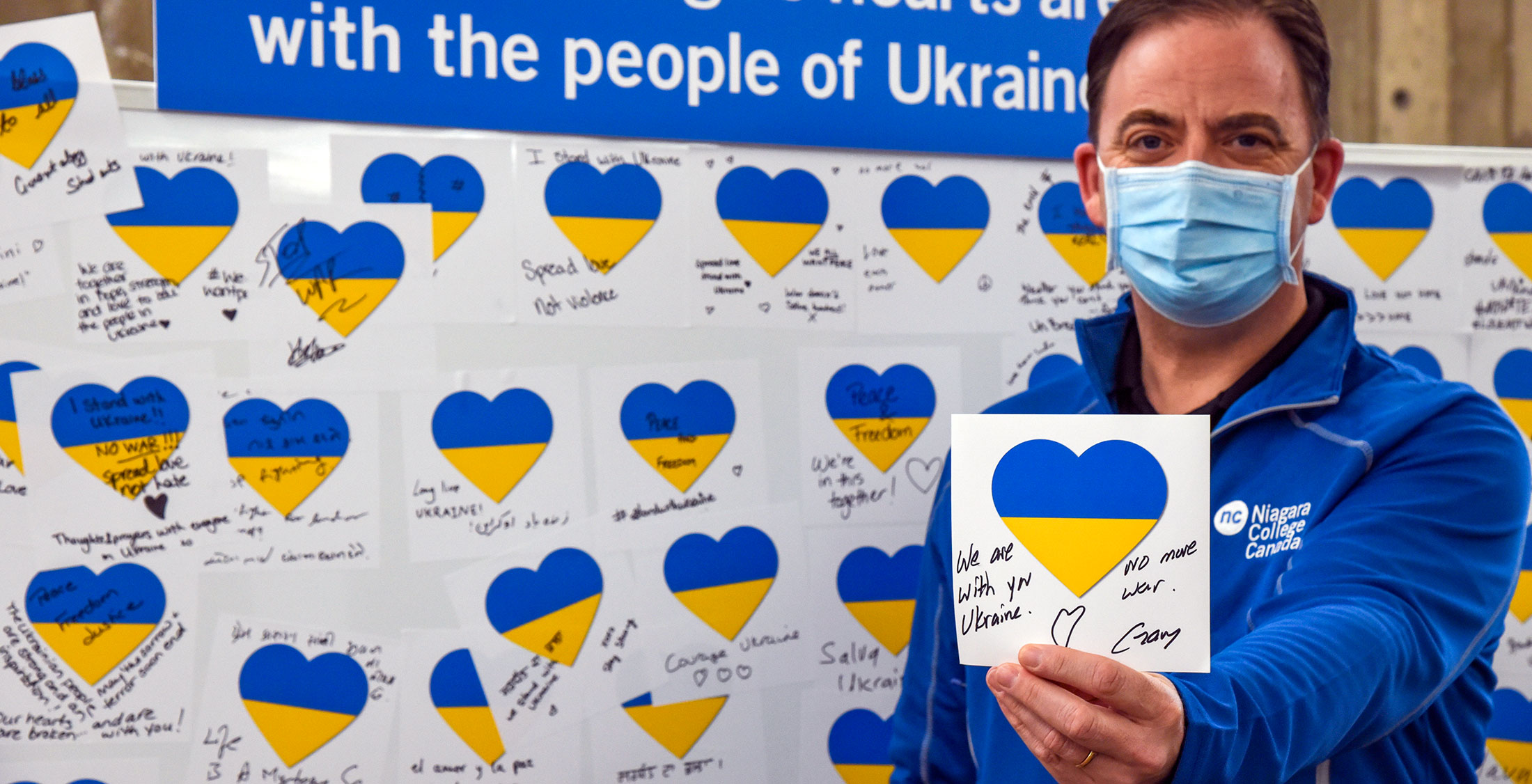 Gary Torraville holding up a Ukraine support heart