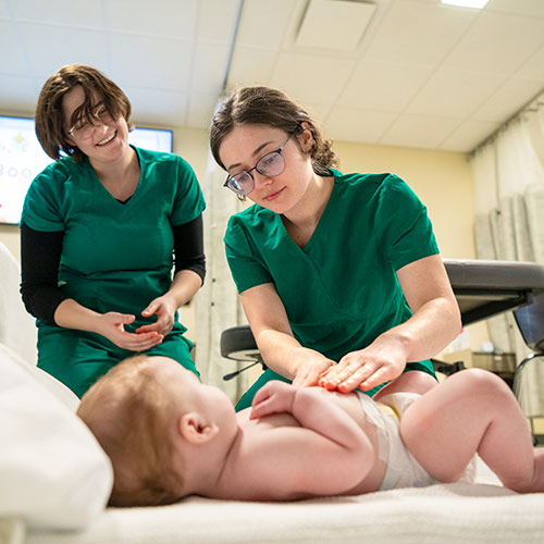 Baby Massage in Massage Therapy program with two students