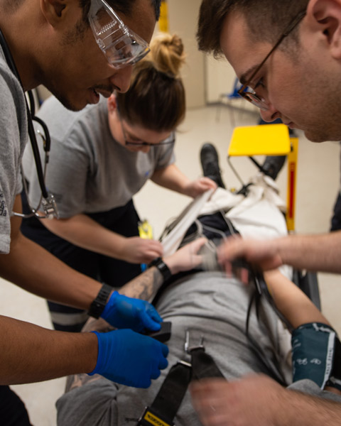 Paramedic students practicing in lab